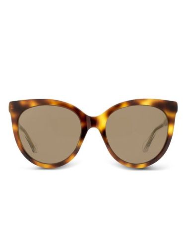 Lunettes de soleil à effet écaille de tortue - Gucci Eyewear - Modalova