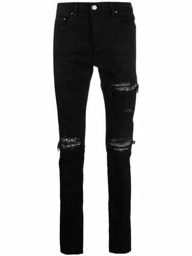 Jean skinny à finitions effilochées - AMIRI - Modalova