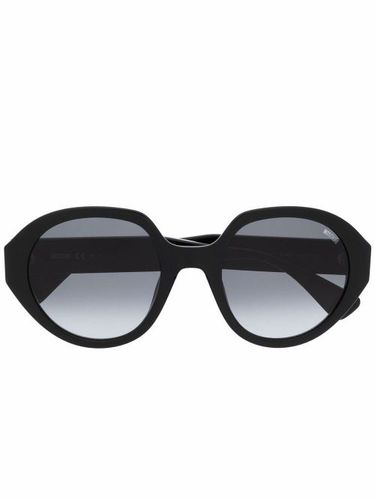 Lunettes de soleil à monture ronde - Moschino Eyewear - Modalova