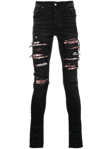 Jean skinny à finitions effilochées - AMIRI - Modalova