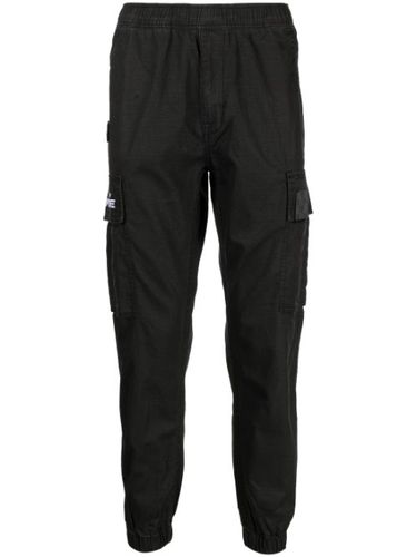 Pantalon fuselé à poches cargo - AAPE BY *A BATHING APE® - Modalova