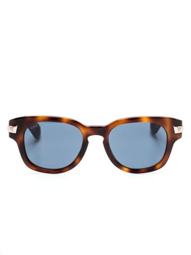 Lunettes de soleil à effet écailles de tortue - Gucci Eyewear - Modalova