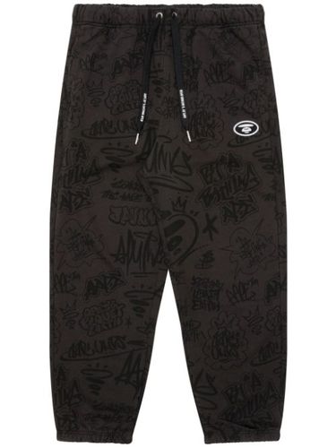 Pantalon de jogging à imprimé graffiti - AAPE BY *A BATHING APE® - Modalova