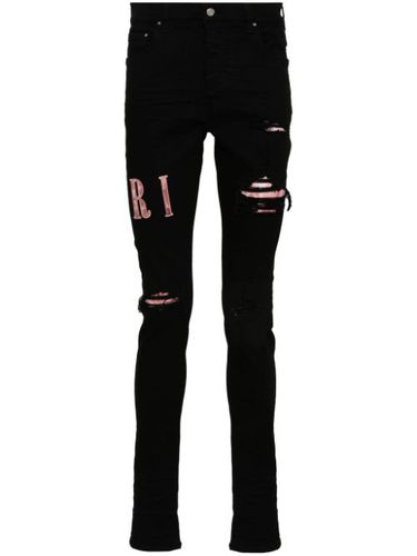 Jean skinny à logo appliqué - AMIRI - Modalova