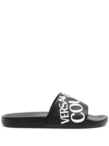 Claquettes à logo en embossé - Versace Jeans Couture - Modalova