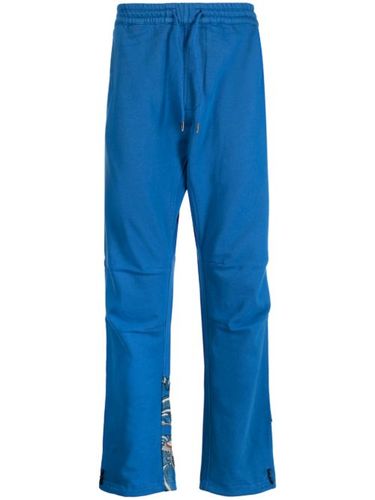 Pantalon en coton à imprimé graphique - Maharishi - Modalova
