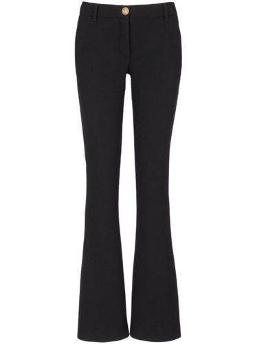 Pantalon en laine vierge à coupe évasée - Balmain - Modalova