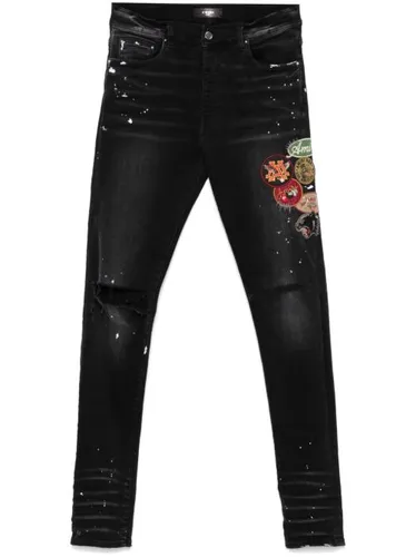 Jean skinny à détail de patch - AMIRI - Modalova