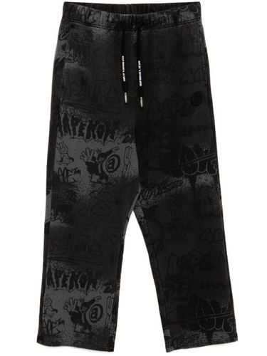 Pantalon de jogging à imprimé graffiti - AAPE BY *A BATHING APE® - Modalova