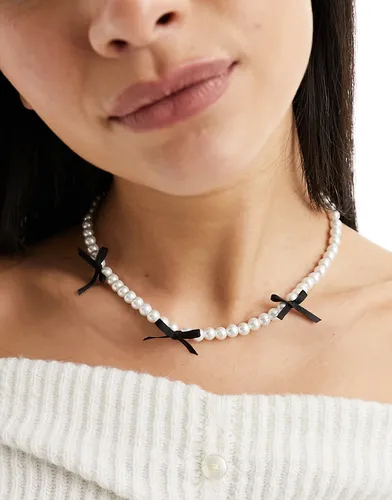 Collier à perles fantaisie et nauds noirs - Asos Design - Modalova