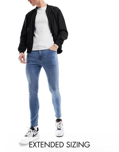 Jean seconde peau en tissu power stretch - délavé foncé - Asos Design - Modalova