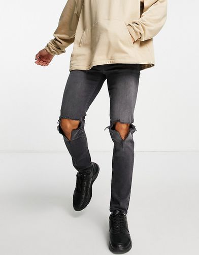Jean skinny avec genoux déchirés - délavé - Asos Design - Modalova