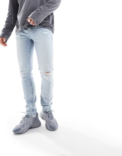 Jean skinny teinté avec déchirures - clair délavé - Asos Design - Modalova