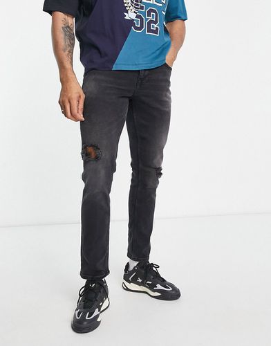 Jean slim stretch avec abrasions - délavé - Asos Design - Modalova