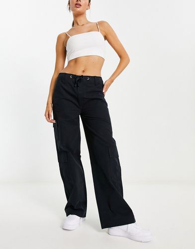 Pantalon cargo oversize avec poches et lien noué à la taille - Asos Design - Modalova