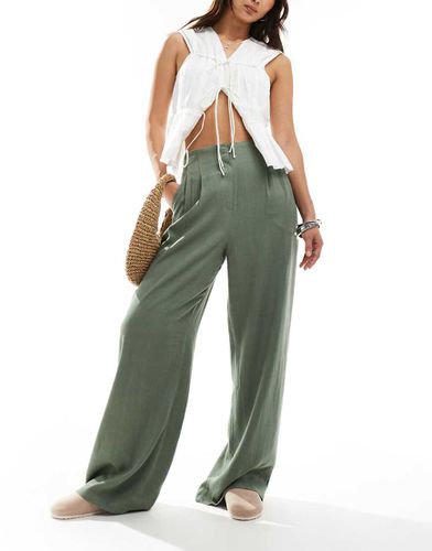 Pantalon ajusté ample en lin avec taille haute et surpiqûres - Kaki - Asos Design - Modalova