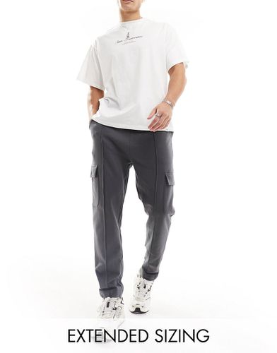 Pantalon de jogging fuselé à poches cargo et nervures - Noir délavé - Asos Design - Modalova
