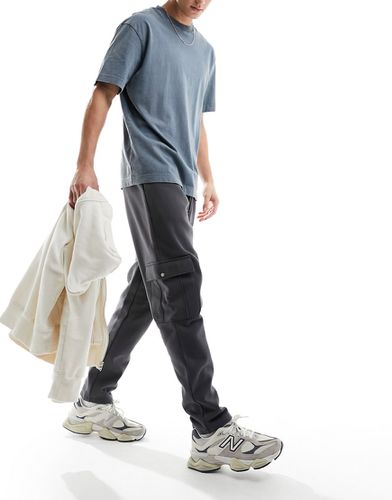 Pantalon de jogging fuselé oversize avec poches cargo - Noir délavé - Asos Design - Modalova