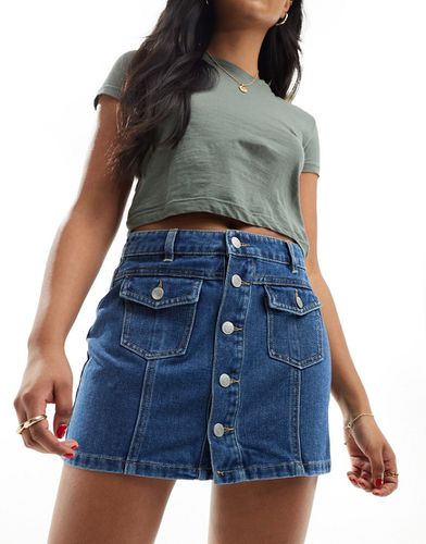 Mini-jupe boutonnée en jean - moyen délavé - Vero Moda - Modalova