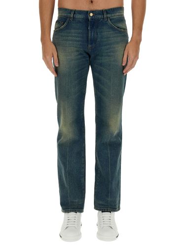 Jeans with logo plaque - dolce & gabbana - Modalova