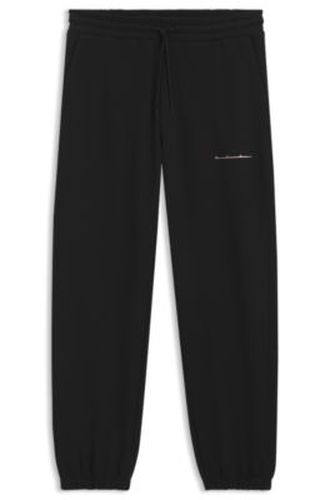 Pantalon Relaxed en coton à logo urbain - HUGO - Modalova
