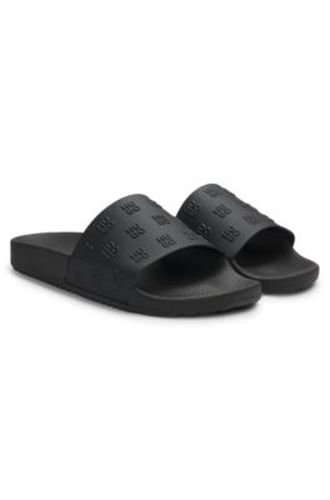 Mules avec tige à logo superposé répétitif - HUGO - Modalova