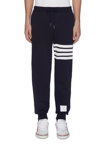 Four bar slogan patch sweatpants - THOM BROWNE - Modalova