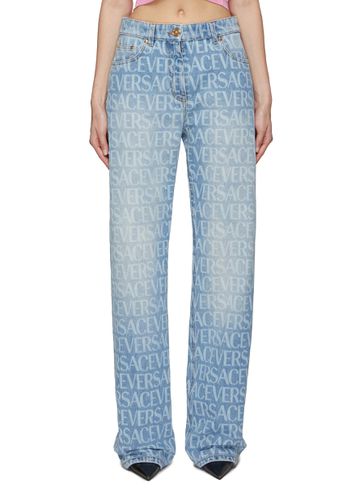 All Over Logo Washed Straight Jeans - VERSACE - Modalova