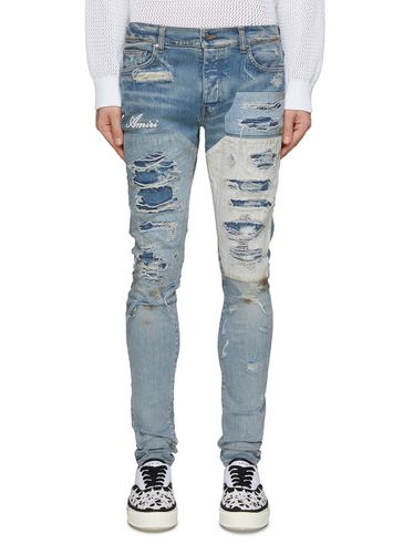 Distressed Patchwork Skinny Jeans - AMIRI - Modalova