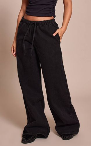 Black Jean Large Taille Haute Élastiquée Avec Lien En Denim Petite | Taille 42 - PrettyLittleThing - Modalova